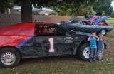 Danny Myrick and his No. 1 car will likely be one of the favorites on Sunday when the Central Valley Mini Stock race again. Pictured are two students from Cox Elementary School in Clovis.